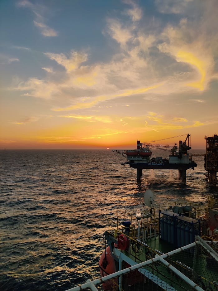 mobile-01 Dramatic sunset over an offshore oil rig in the Persian Gulf, showcasing industry and nature.